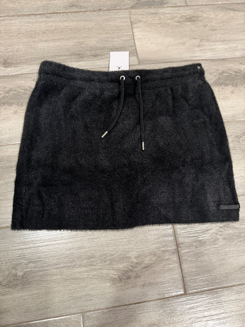 Black Air Jordan mini skirt with drawstring waist, size XL. Brand new with tags.
